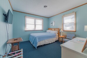 A bedroom with a bed, two windows, a desk, and a chair. - JL #656 | Terrill Cottage | Semi-Oceanfront | Horizon Ocean View (Kitty Hawk)