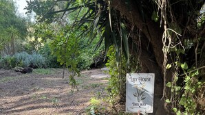 A sign for 'Lily House' with a path leading through a garden. - Pacific Coast Highway Lily House (San Luis Obispo)