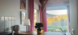 A room with a view of trees, a lamp, a potted plant, and a tiled wall. - Villa at Domaine de l'Espinet - Quillan 11500 (Quillan)