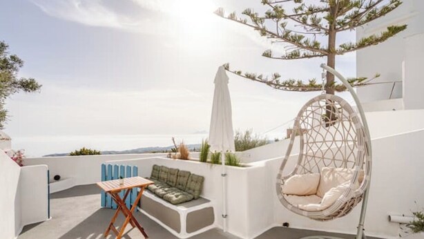 A rooftop terrace with a hanging chair, a small table, and a sofa. - Aura 1-bedroom apartment with AC and WiFi in charming Thira (Thira)