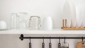 A kitchen counter with various glassware and plates. - Aura 1-bedroom apartment with AC and WiFi in charming Thira (Thira)