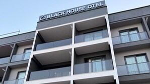 A multi-story building with a sign reading 'BLACK HOUSE HOTEL' at the top. - BLACK HOUSE OTEL TURİZM  (Mersin)