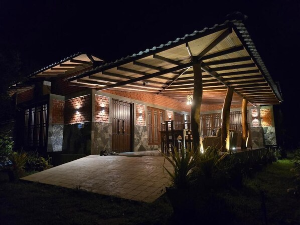 A house with a covered patio, brick walls, and a tiled entrance. - Ceylon resort wilpattu (Wilpattu)