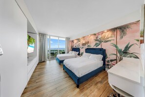 A hotel room with two beds, a large window with a view, and a tropical-themed wall mural. - Arya Hotel Studio Apartment Coconut Grove, Ocean View and Free Parking (Miami)