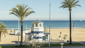 A beachside building with a small tower, palm trees, and the ocean in the background. - AG DUPLEX 2-3 PREMIUM - only families (Playa de Gandía)