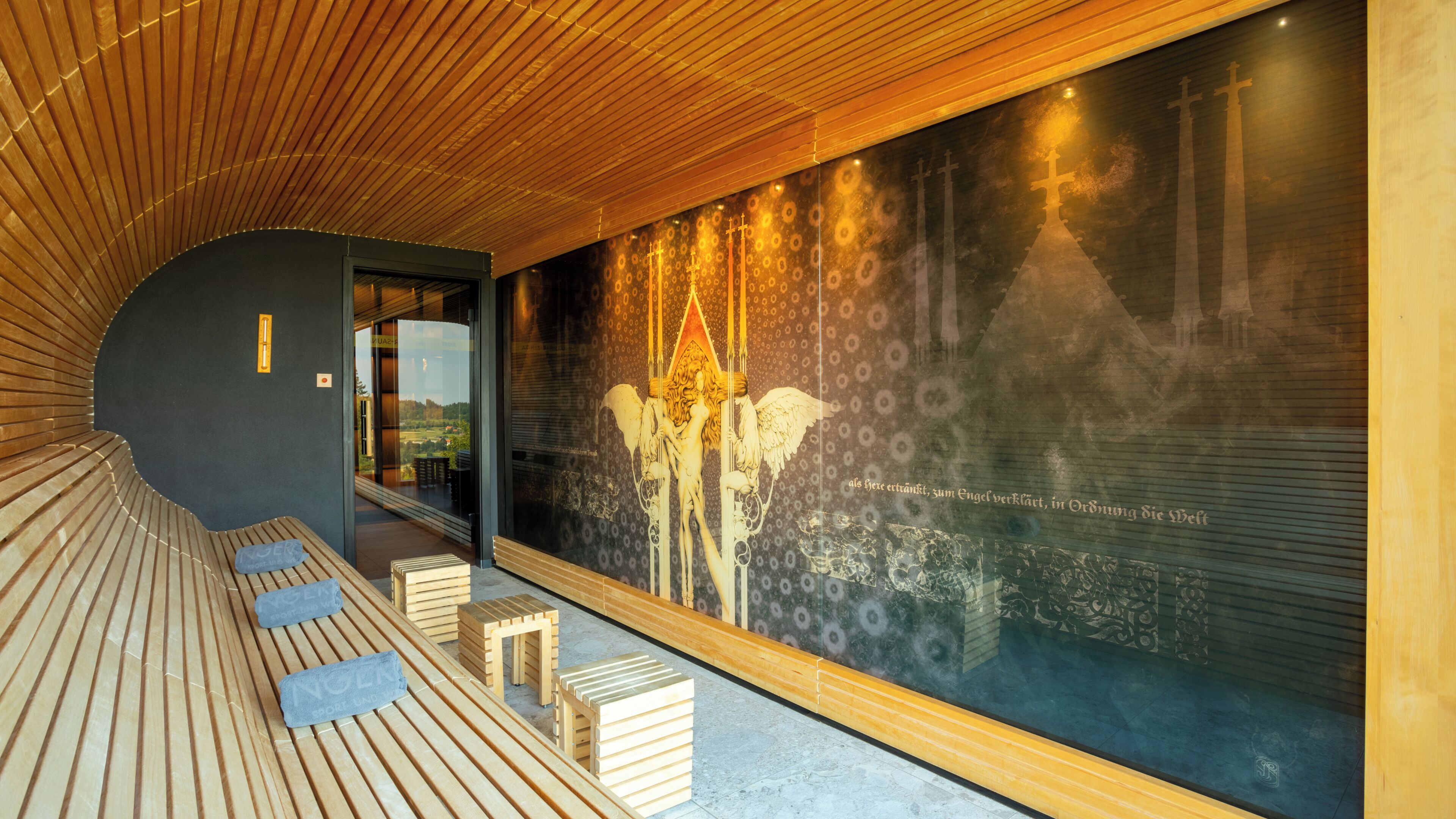 A modern spa with wooden benches, a large mural, and a view of the outdoors.