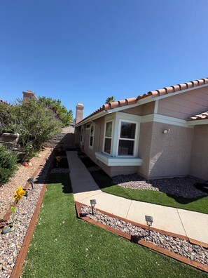 A residential house with a tiled roof, a paved driveway, and a well-maintained lawn. - Vegas Hideaway conveniently located from airport and strip 8-20 minutes. . . (Las Vegas)