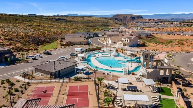 A residential area with a swimming pool, tennis courts, and a hilly landscape in the background. - Game loft, Nerf Wars, Resort Pool, Lazy River & Waterslide • Near Zion (Washington)