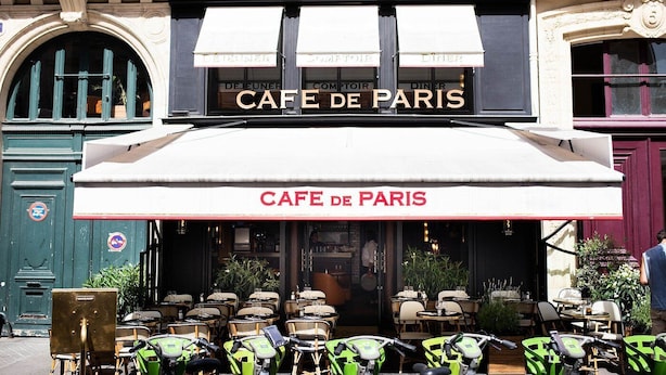 Café com área externa e placa indicando 'CAFE DE PARIS'.