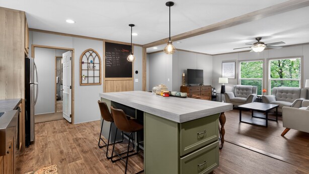 A modern kitchen with a central island, bar stools, a chalkboard with a list, and a dining area with chairs and a table. - Lake Front - Privately Owned Dock with Boat Launch (Quitman)