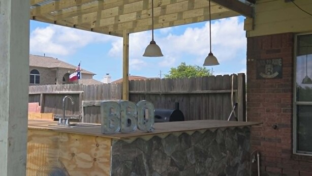 An outdoor kitchen area with a BBQ grill, a sink, and hanging pendant lights. - Hook, Line & Relax – Coastal TX Getaway (Texas City)