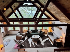 Ein großzügiger Loft-Raum mit hohen Decken, großen Fenstern und einer gemütlichen Sitzecke.