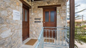 Un bâtiment en pierre avec une porte en bois et une enseigne indiquant « Livadi Loft ».