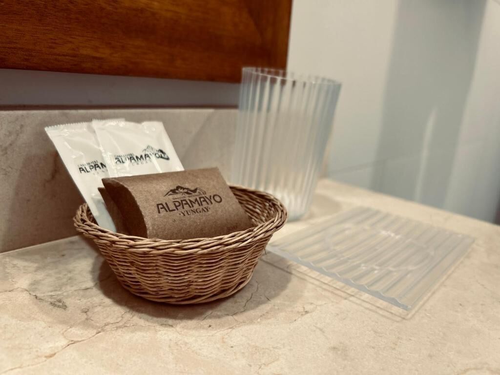 A wicker basket with a brown paper bag labeled 'ALPPIMAYO' on a marble countertop.