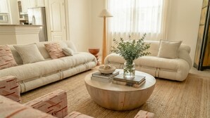 A living room with two sofas, a coffee table, and a floor lamp. - Ridge House with Pool, Hot Tub, Stars; near Joshua Tree & Pioneertown (Yucca Valley)