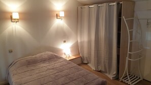 A bedroom with a bed, two wall-mounted lights, a curtain, and a ladder. - Duplex house on the edge of a wood, nearby beaches, forest and golf course (Moliets-et-Maa)