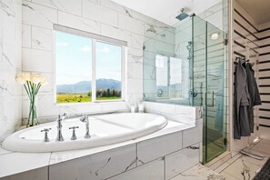 Jetted tub, hair dryer, towels, soap