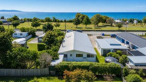 A residential area with a house, RVs, and a marina. - The Bach - Home away from Home in Pohara (Pōhara)