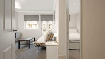 A bedroom with a bed, a bedside table, a desk, and a chair.