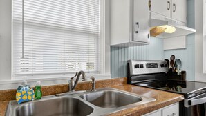 A kitchen with a double sink, stainless steel appliances, and a window with blinds. - UNIT C: Walk to Beach/Intercoastal/Fishing Pier (Holly Ridge)