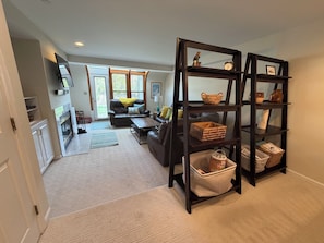 A living room with a fireplace, a sofa, a coffee table, and a bookshelf.
