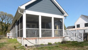 A single-story house with a covered porch, a front staircase, and a visible front yard. - Rehoboth Beach House Pet Friendly Fenced Yard Next to Trail (Rehoboth Beach)
