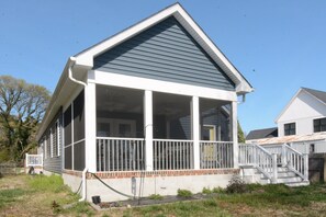 A single-story house with a covered porch, a front staircase, and a visible front yard. - Rehoboth Beach House Pet Friendly Fenced Yard Next to Trail (Rehoboth Beach)