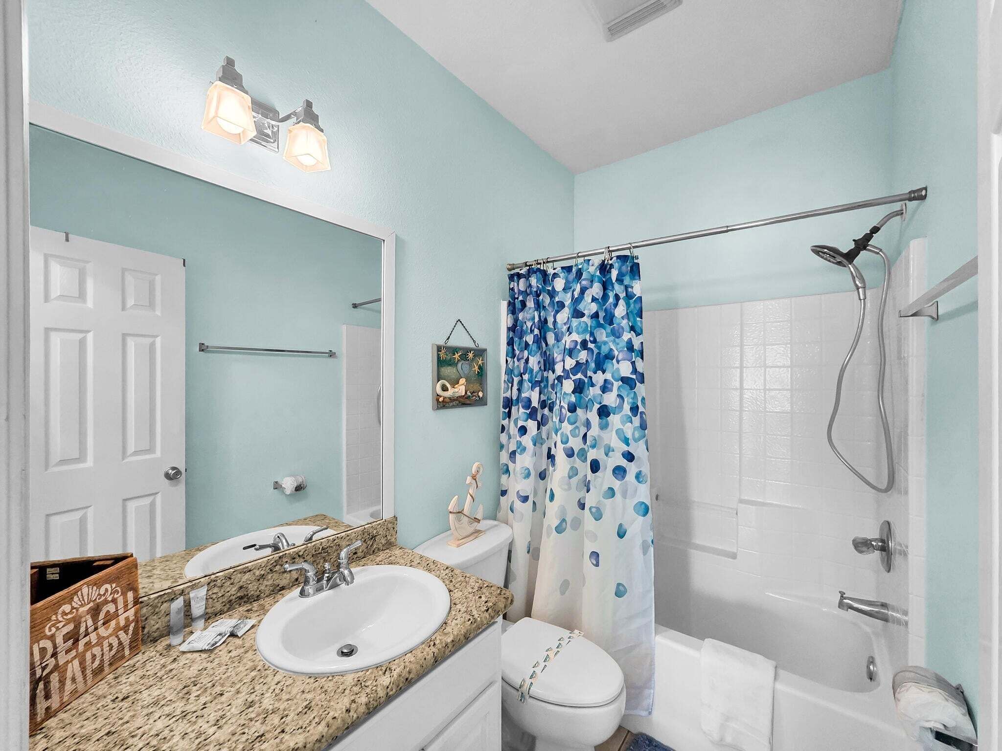 A bathroom with a sink, toilet, and shower.