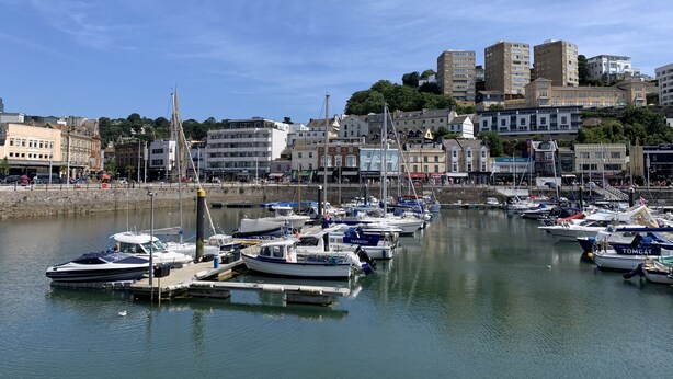 A marina with boats docked, a waterfront promenade, and buildings in the background. - Harbour Lights Apartment, a coastal retreat set on Torquay's vibrant marina (Torquay)