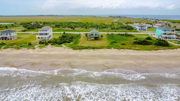 A coastal area with beachfront properties, a road, and a view of the ocean. - Bolivar Bliss 3 Bedroom Home (Port Bolivar)