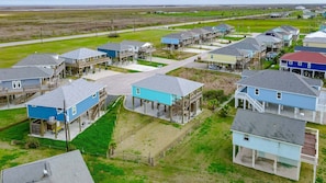 A coastal residential area with houses featuring balconies and waterfront views. - Afterdunedelight 3 Bedroom Home (Port Bolivar)