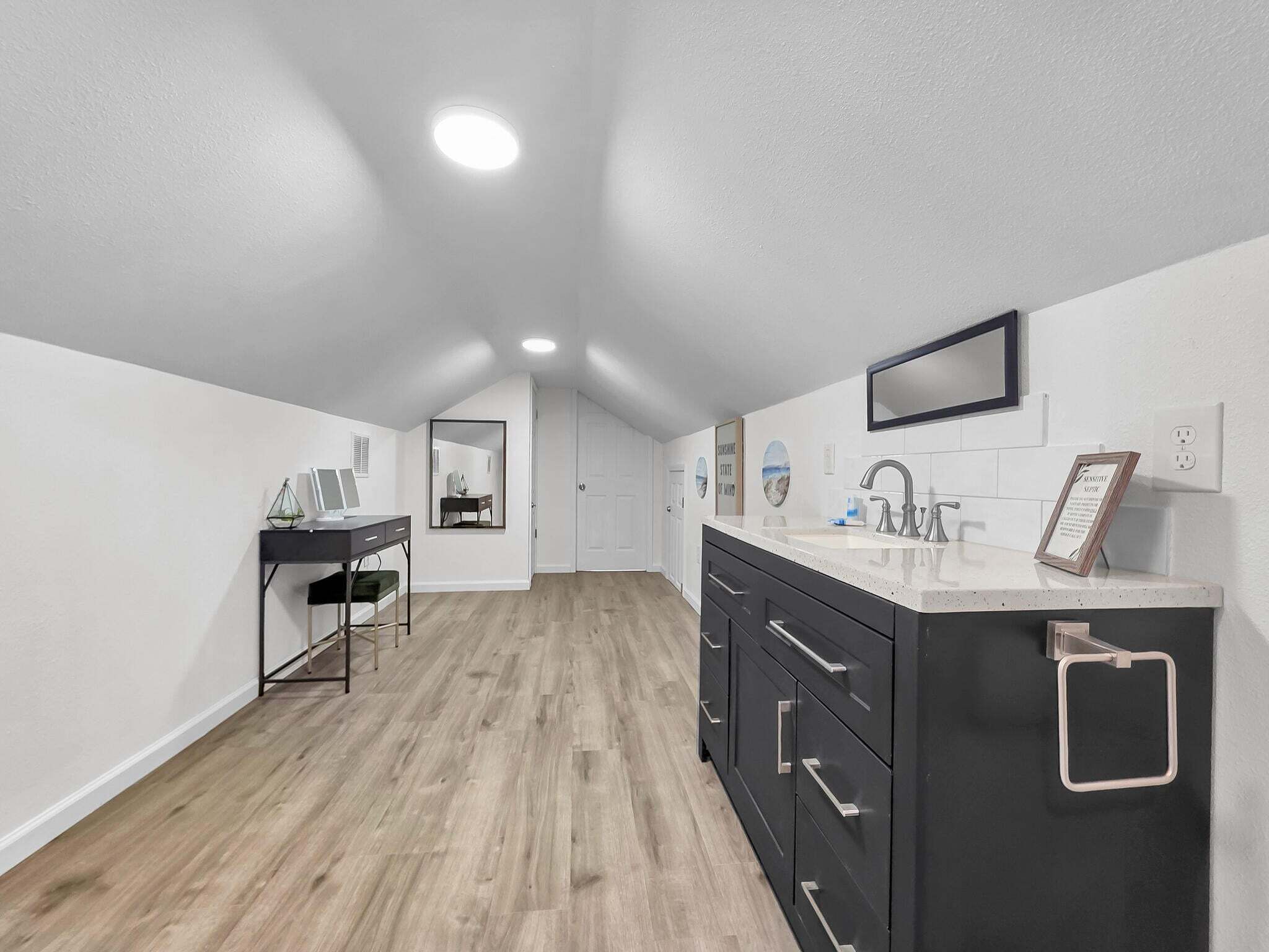 A modern kitchen with a countertop, sink, and cabinets.