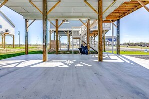 A building under construction with exposed wooden beams and a concrete floor. - Sea You Soon 2 Bedroom Home (Coffeyville)