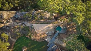 An aerial view of a property with a swimming pool, a wooden deck, and surrounding greenery. - Patonga House: Stunning Views, Privacy, Heated Pool and Panoramic Outdoor Sauna (Patonga)