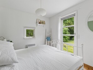 A bedroom with a bed, a window, a wall-mounted shelf, and a radiator. - "Niela" - 400m from the sea by Interhome (Kalundborg)