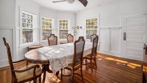 A dining room with a table, chairs, and a ceiling fan. - 9BR Sleeps 19 - 1 Block to Beach - Ocean Views! (Ventnor City)