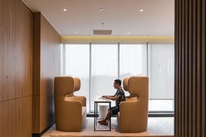 A modern interior with two leather chairs, a small table, and a large window. - TROY HOUSE - MASTERI WEST HEIGHTS (Hanoi)