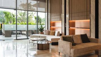 A modern interior with a sofa, armchairs, and a coffee table.