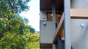 A modern building with a sign reading 'KOYADO NAGOMI'. - koyado Nagomi (Kobe)