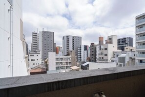 A cityscape with various buildings, including high-rise apartments and commercial structures. - Rafine Nihonbashi (Osaka)