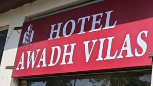 A red sign with white text for 'Hotel Awadh Vilas.' - Hotel Awadh Vilas (Ayodhya)
