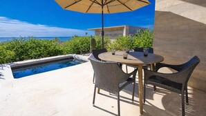 An outdoor seating area with a pool, a table, chairs, and an umbrella. - Ocean View Luxury Surf Casita 1    
    IG RanchoAguaSal (Playa Tortuga)