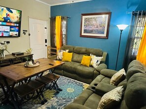 A living room with a sofa, a coffee table, a TV, and a framed picture on the wall. - Your home away from home In Montego Bay (Montego Bay)