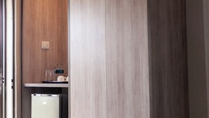 A kitchen with a refrigerator, a countertop, and a wooden cabinet. - Chalo villa's and farm (Chitedze)