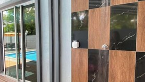 A modern exterior with a glass door leading to a pool area. - 4BR 16pax LYL Jaccuzi Private Pool House ipoh (Ipoh)
