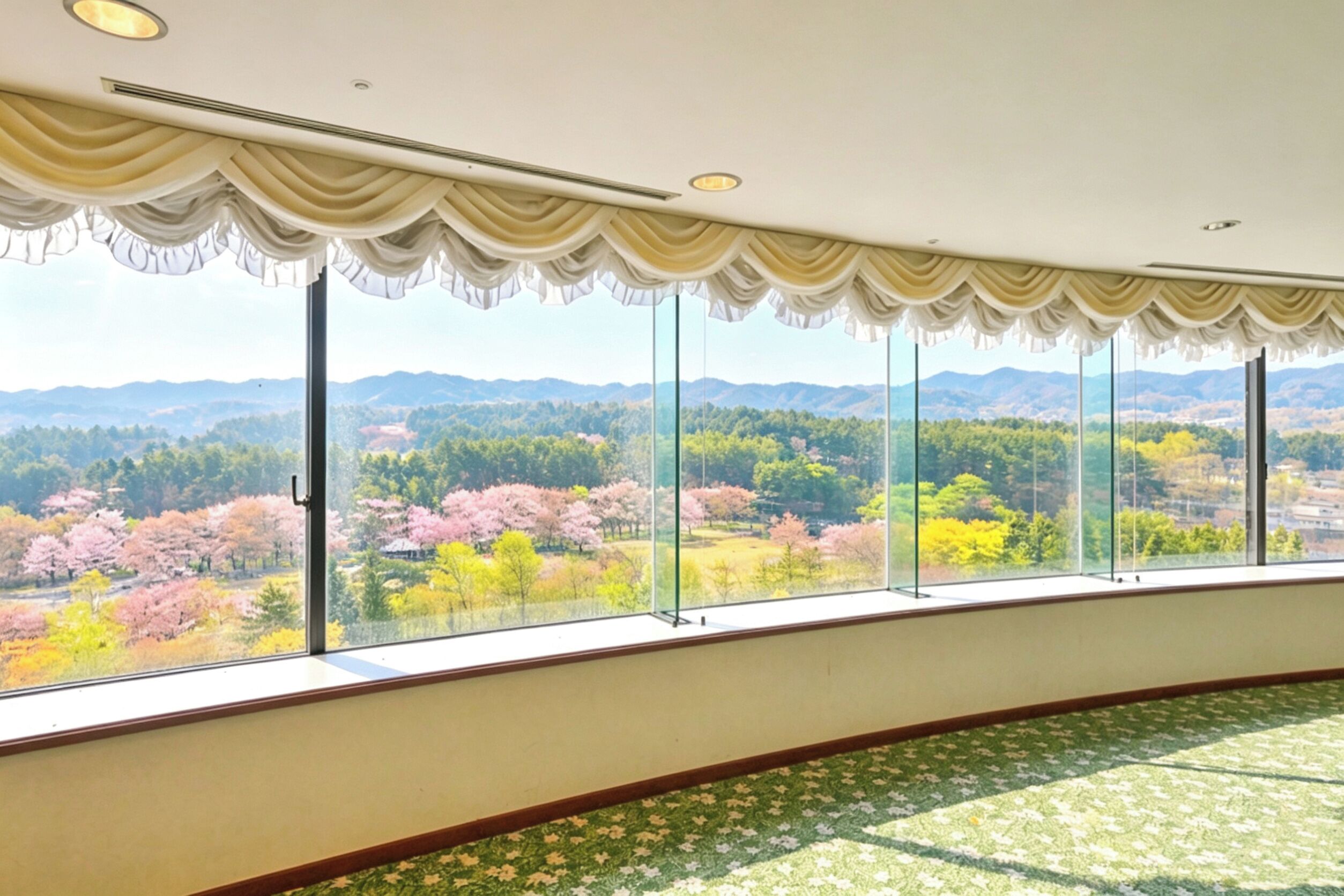 A room with large windows, a patterned carpet, and a view of a landscape with trees.