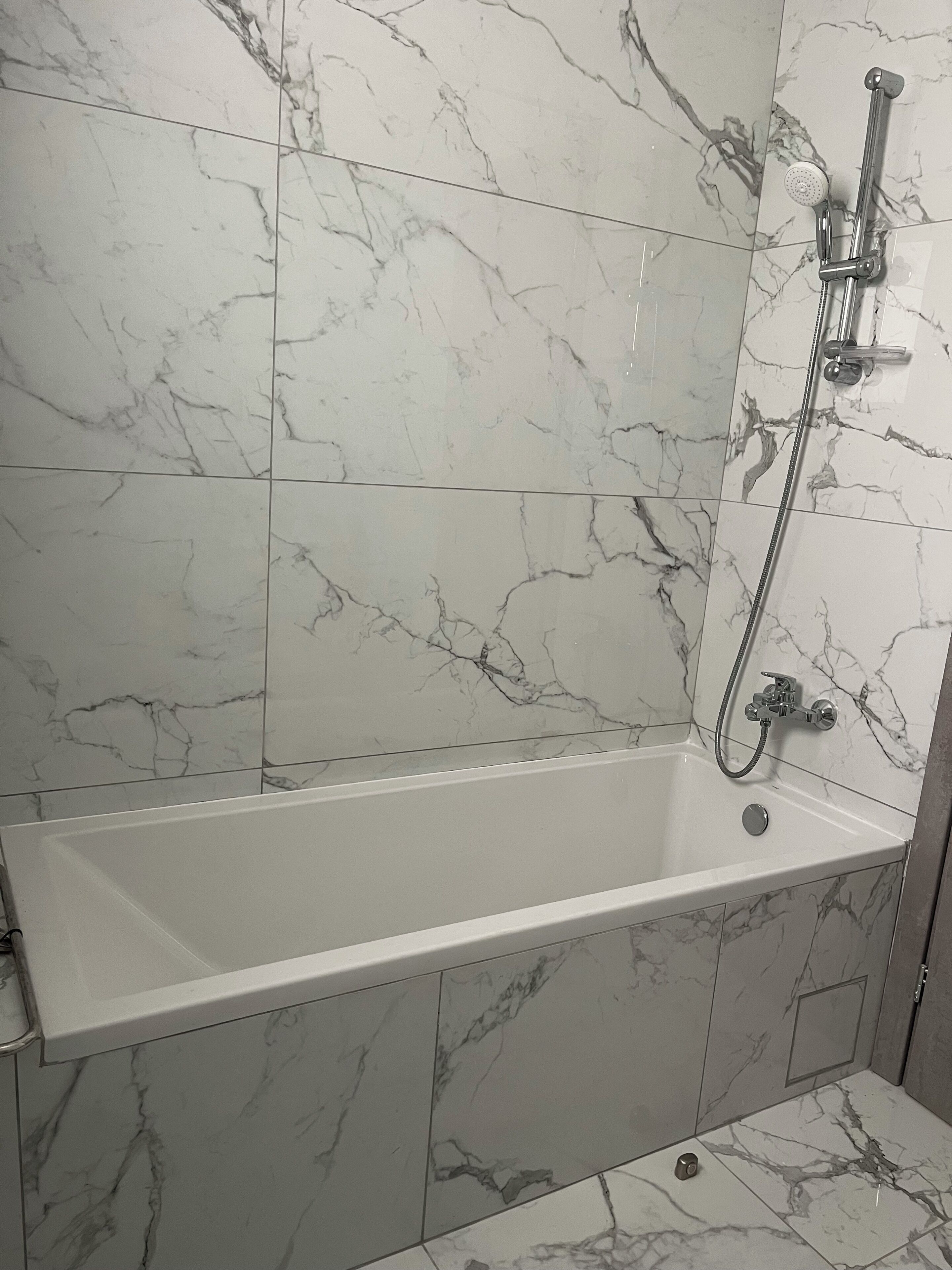 A bathroom with a bathtub, a shower, and a toilet.