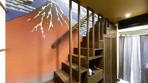 A staircase with wooden railings and a wall mural.