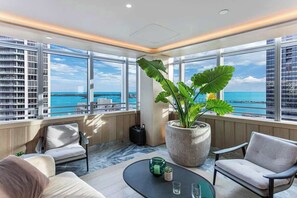 A modern interior with large windows, a potted plant, and a seating area. - Huge 2-Story Brickell Penthouse Free Parking Pool (Miami)