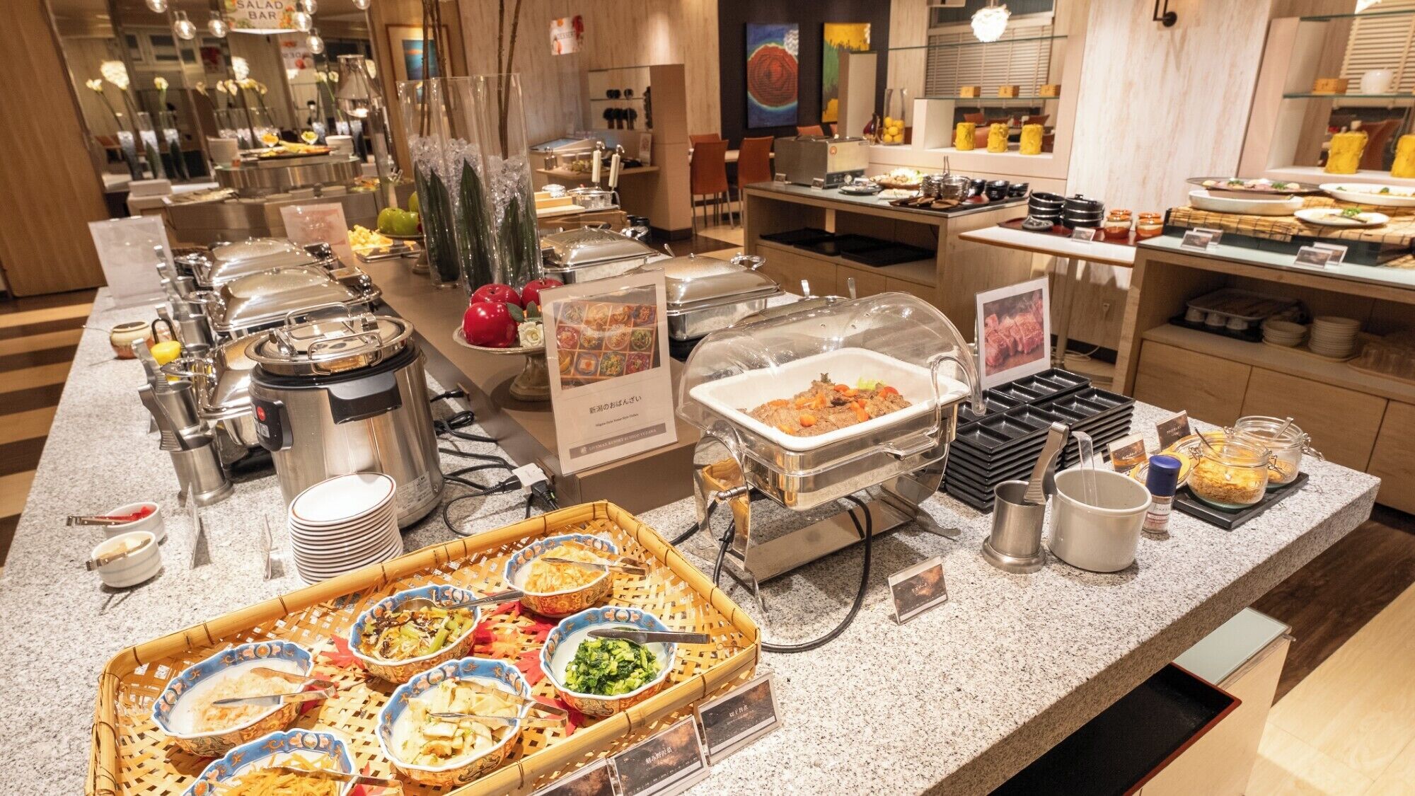 A buffet area with various food stations, including a salad bar, hot dishes, and a variety of side dishes.